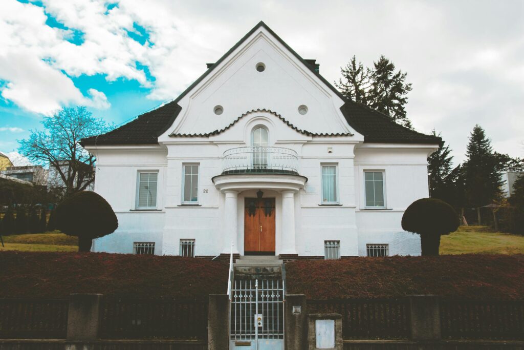 Charming white house with unique architecture and a black roof in Prague, Czech Republic.